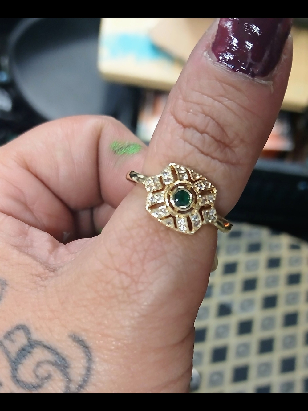 Elegant Gold Ring with Green Center Stone